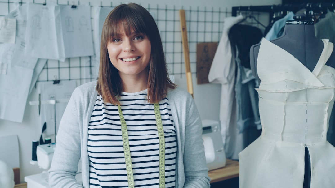 A seamstress smiles in her workshop.