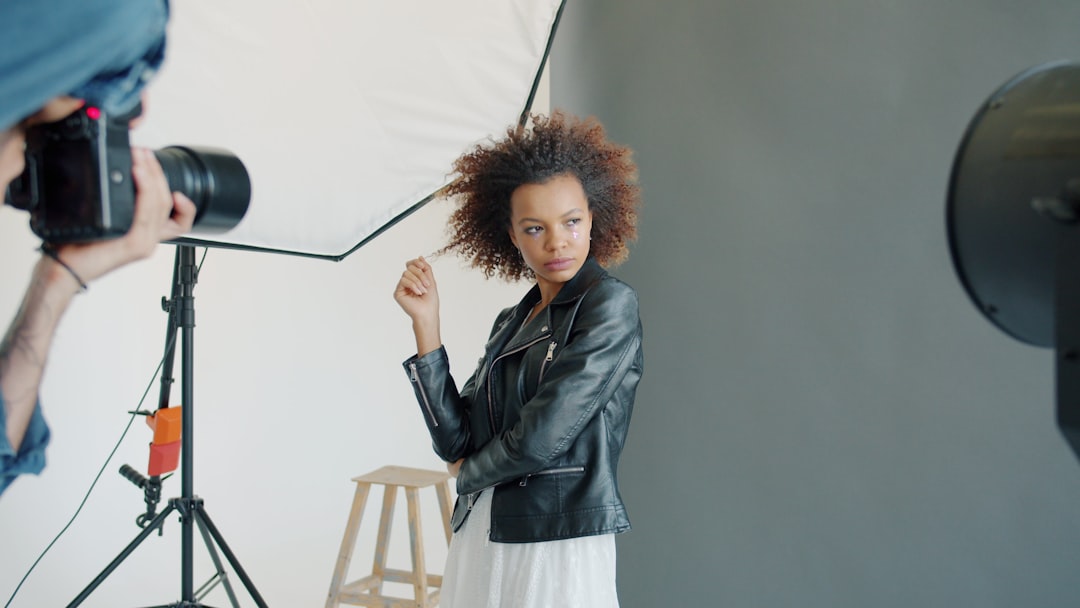 Model posing for photographer in studio lighting