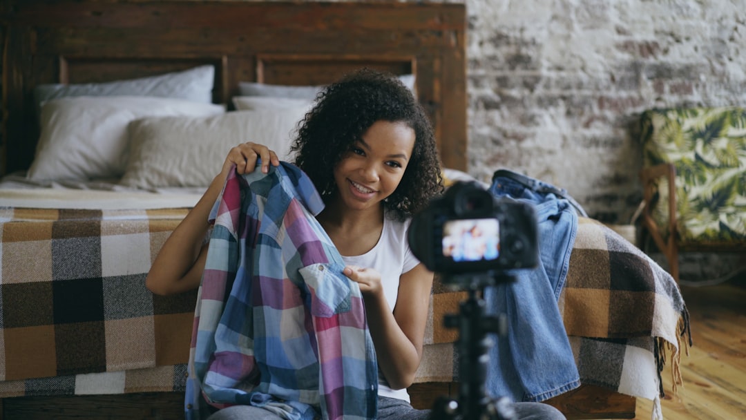 Woman showing clothes to camera for video