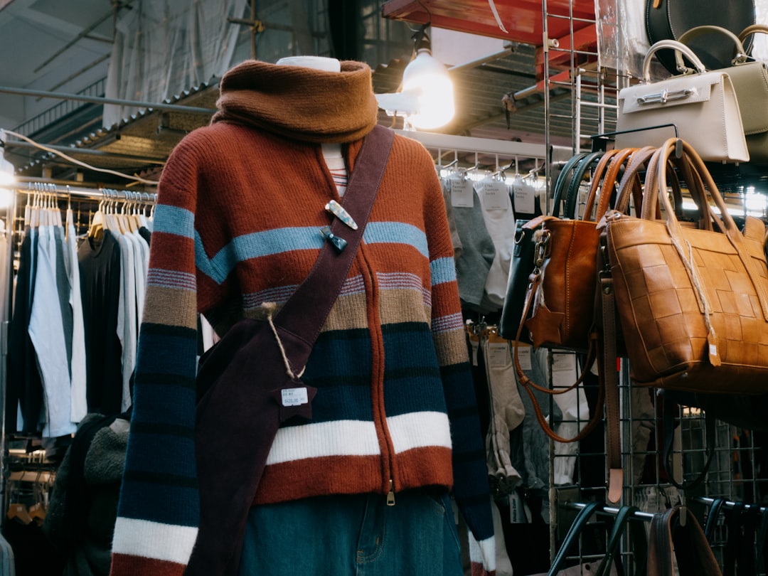 A mannequin wearing a multicolored sweater in a clothing store