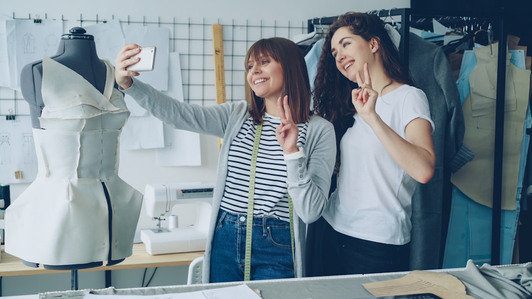 Two designers take a selfie in their workshop.