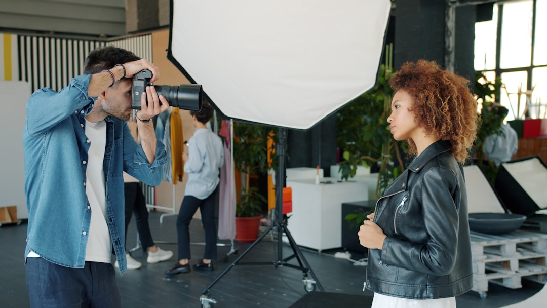 Photographer taking picture of model in studio