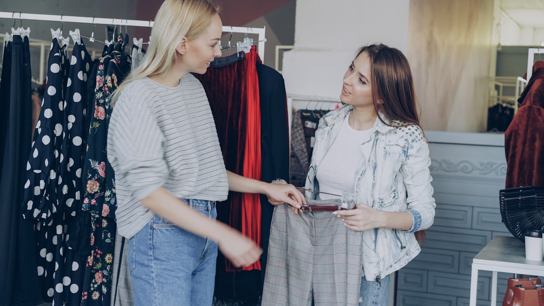 Two women are shopping for clothes together.